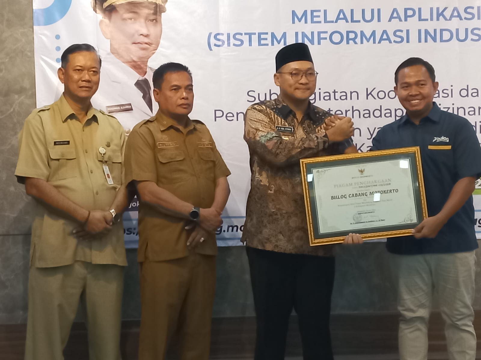 Kepala Perum BULOG Kantor Cabang Mojokerto, Muhammad Husin, S.H., M.H., menerima penghargaan dari Pemerintah Kabupaten Mojokerto atas komitmen mendukung implementasi Sistem Informasi Industri Nasional (SIINas).